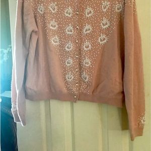 Anne Klein pink sweater with white embellishments.